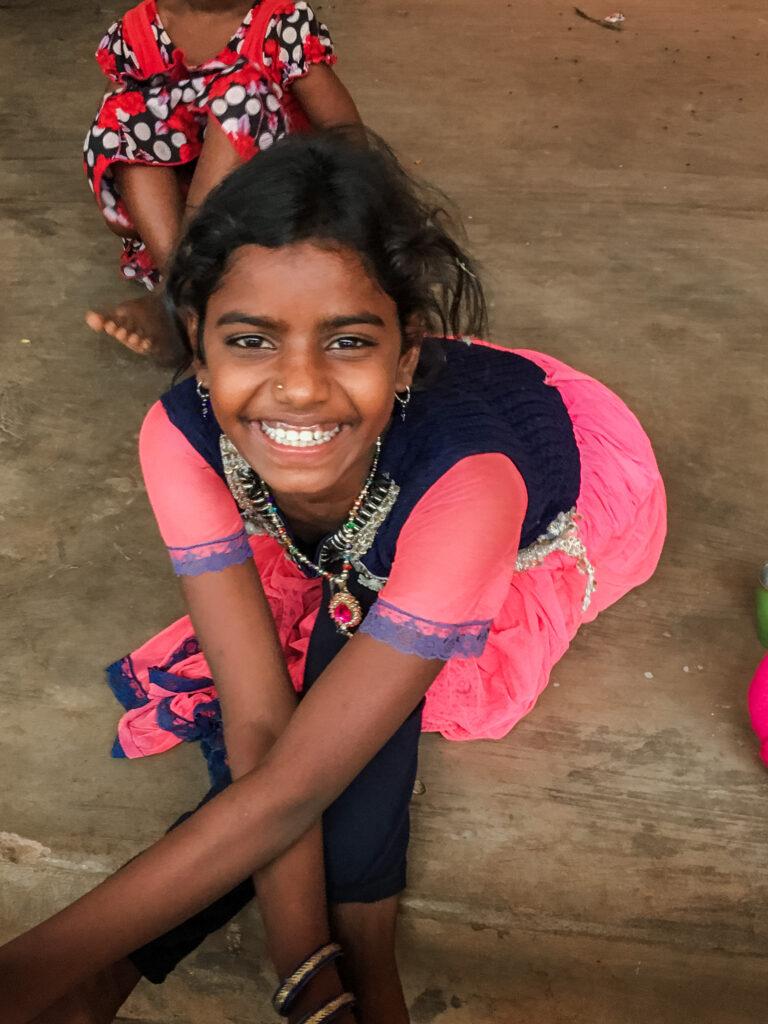 indian orphan girl from christian child sponsor program sits